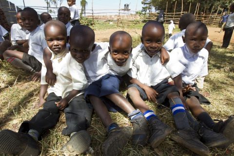 Kids with arms around each other in a schoolyard