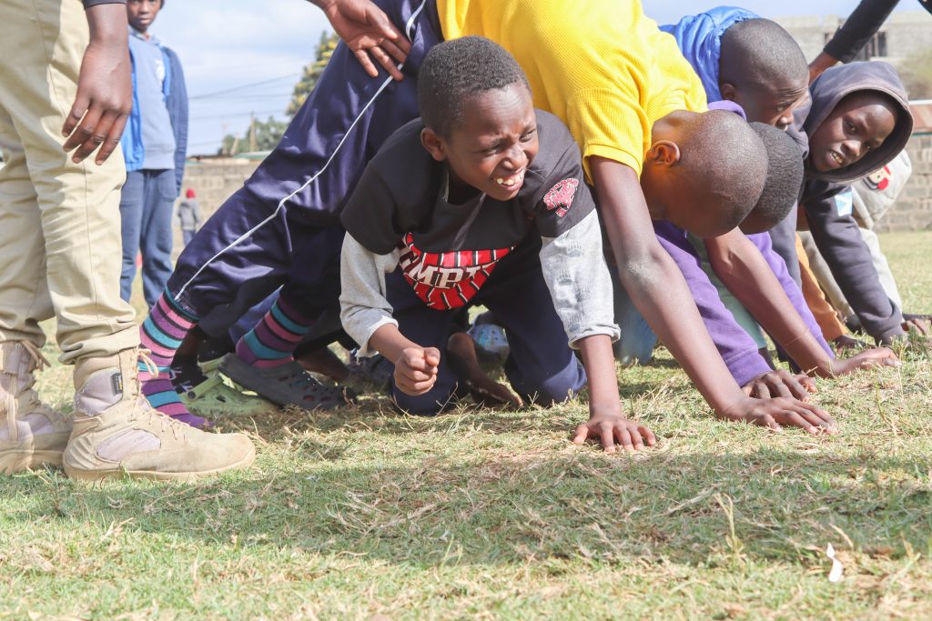 The kids are laughing and having a great time as they play the tunnel game. They are working together to get through the tunnels, and they are all helping each other out. It is a very cooperative and social game, and the kids are clearly enjoying each other's company.